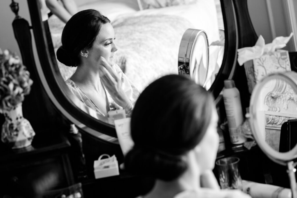 Bride getting ready in front of a mirror - documentary style