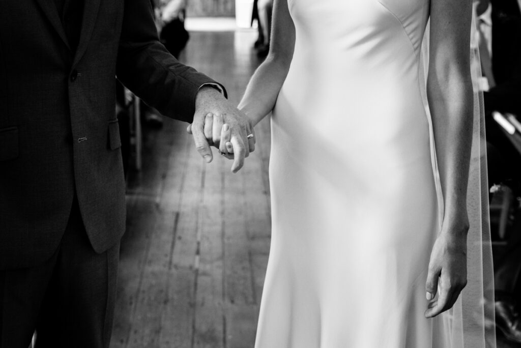 Bride and groom holding hands at alter Wedding Photographer Ottawa