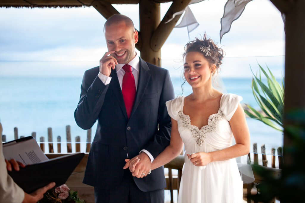 Bride and Groom during Ceremony at Beach by wedding photographer ottawa Sara