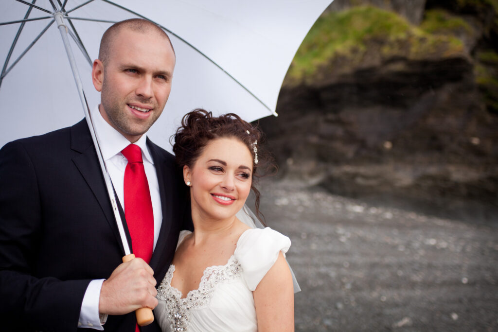 Couple Portrait with umbrella on stone beach Wedding Photographer Ottawa