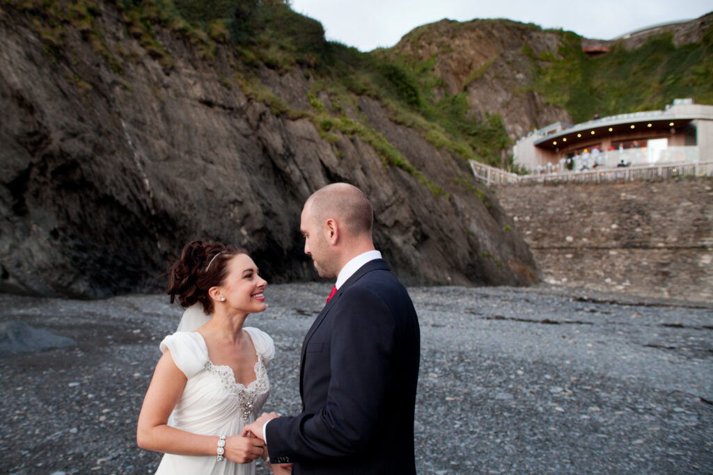 Couple Portrait against cliffs with venue in background Wedding Photographer Ottawa