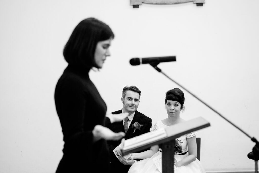 Couple watching reading by a guest by ottawa wedding photographer sara documentary reportage