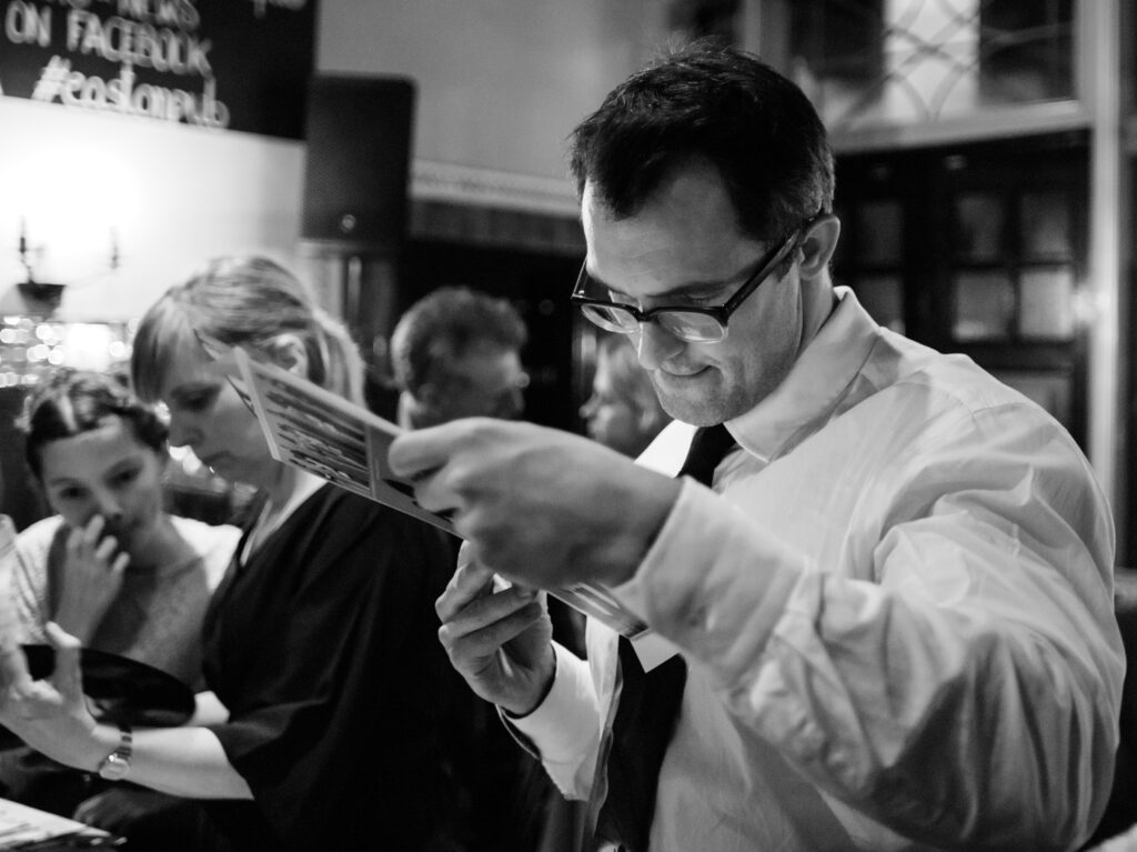 Guest at reception with album by wedding photographer ottawa ontario documentary reportage