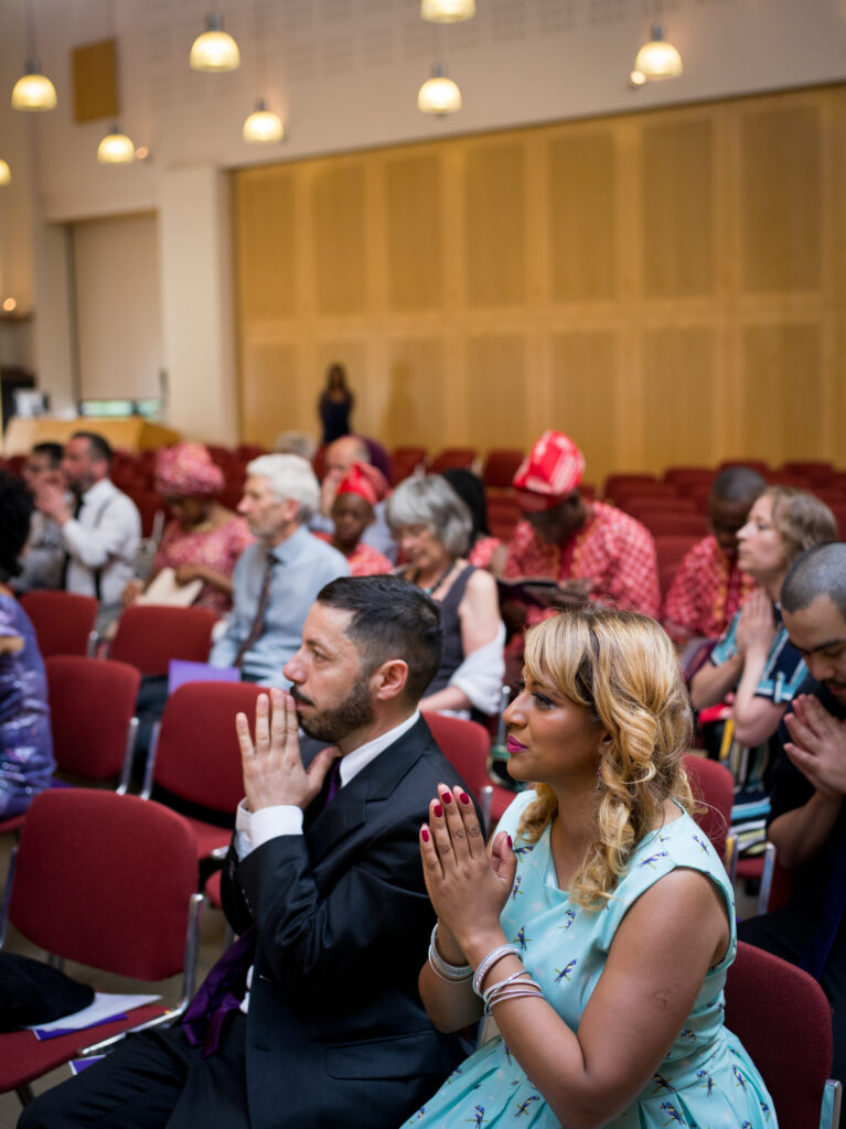 Guests praying during buddhist ceremony by Ottawa Wedding Photographer Sara