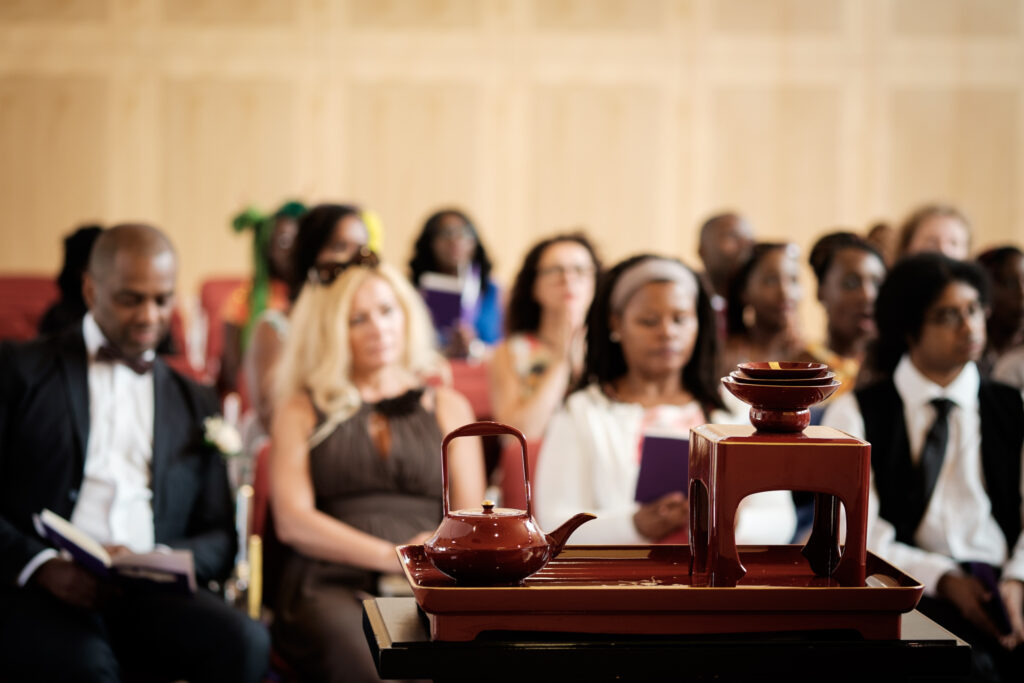 Buddhist tea ceremony with guests in background by Ottawa Wedding Photographer Sara