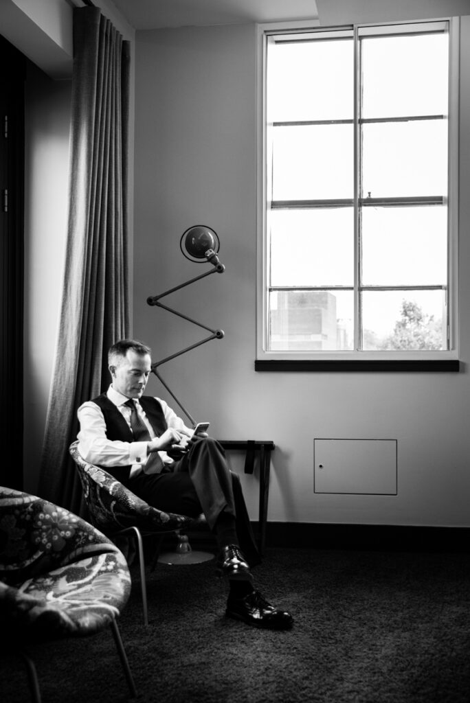 Groom getting ready in hotel before ceremony by Ottawa wedding photographer Sara