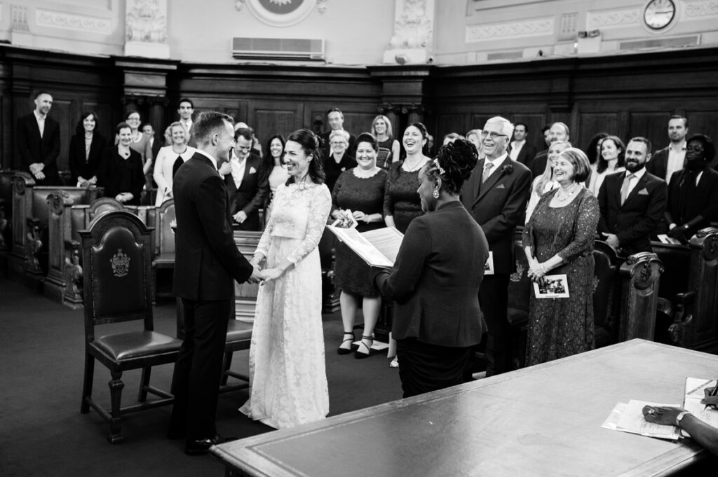 Bride and Groom with family and friends during the ceremony by Ottawa Wedding Photographer Sara
