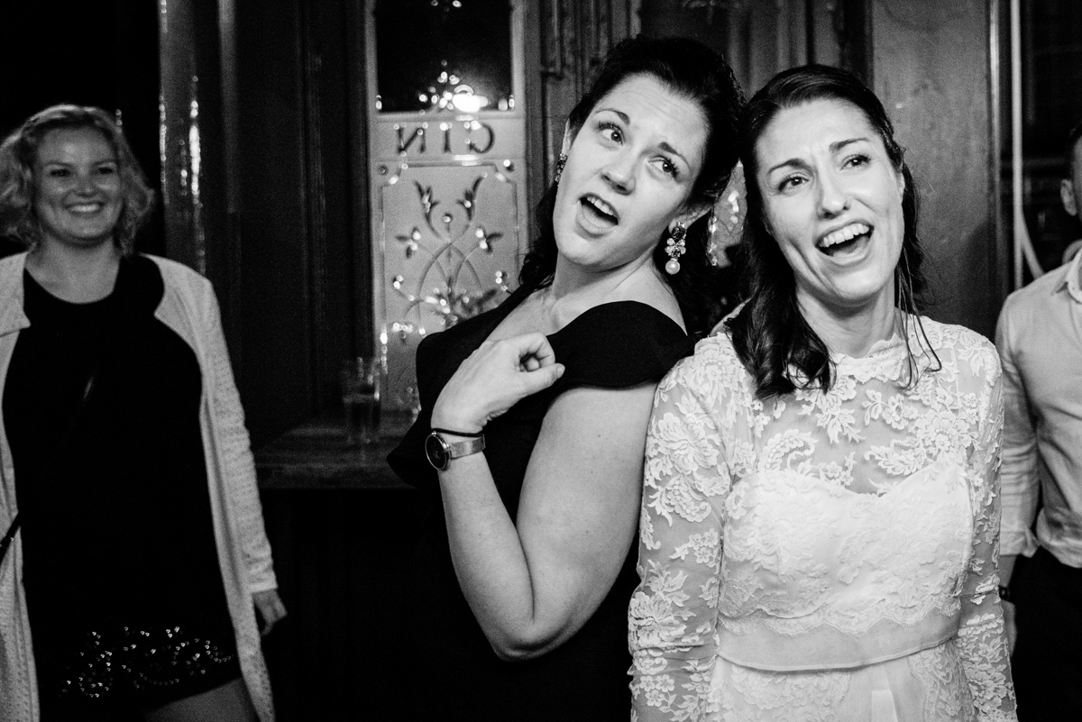 Bride and friend singing at reception by Documentary Ottawa Wedding Photographer Sara