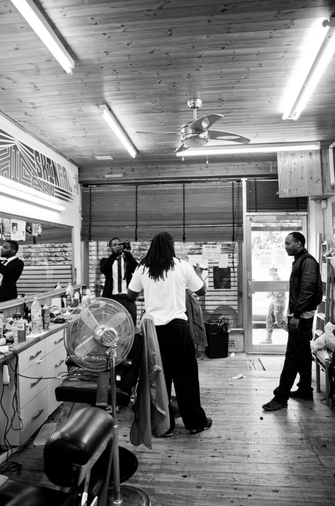 Black and white photograph of men in a barber shop