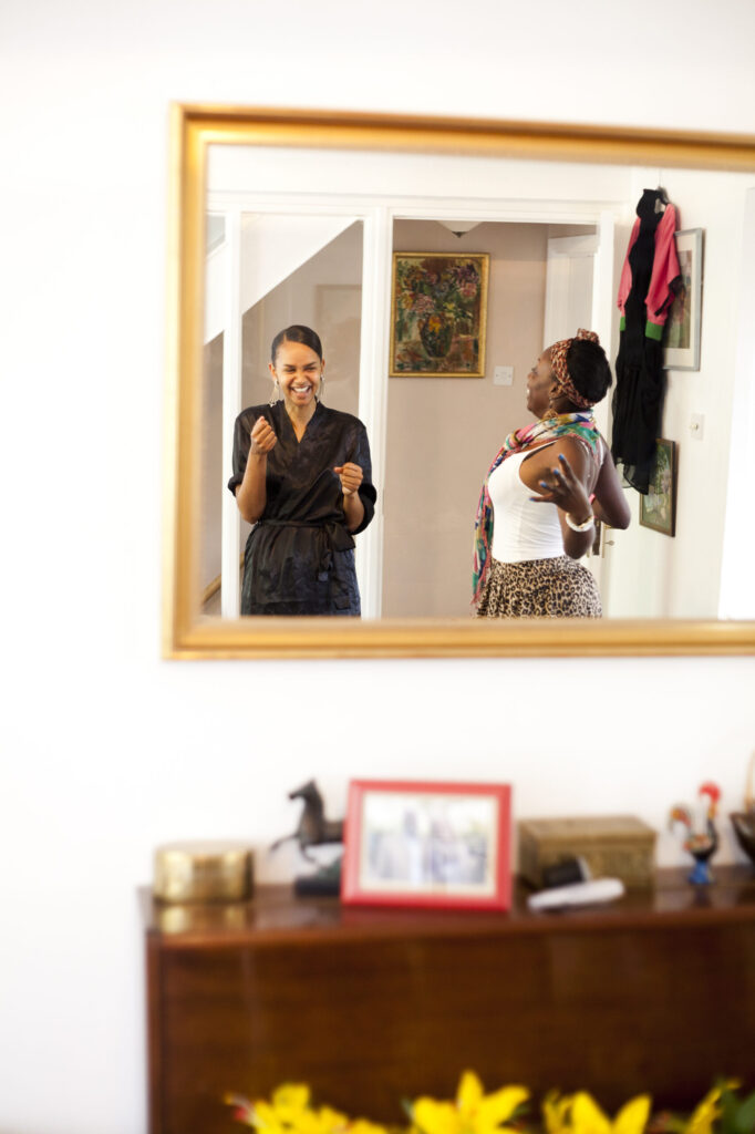 Colour photograph of a bride to be and her friend excited before the wedding