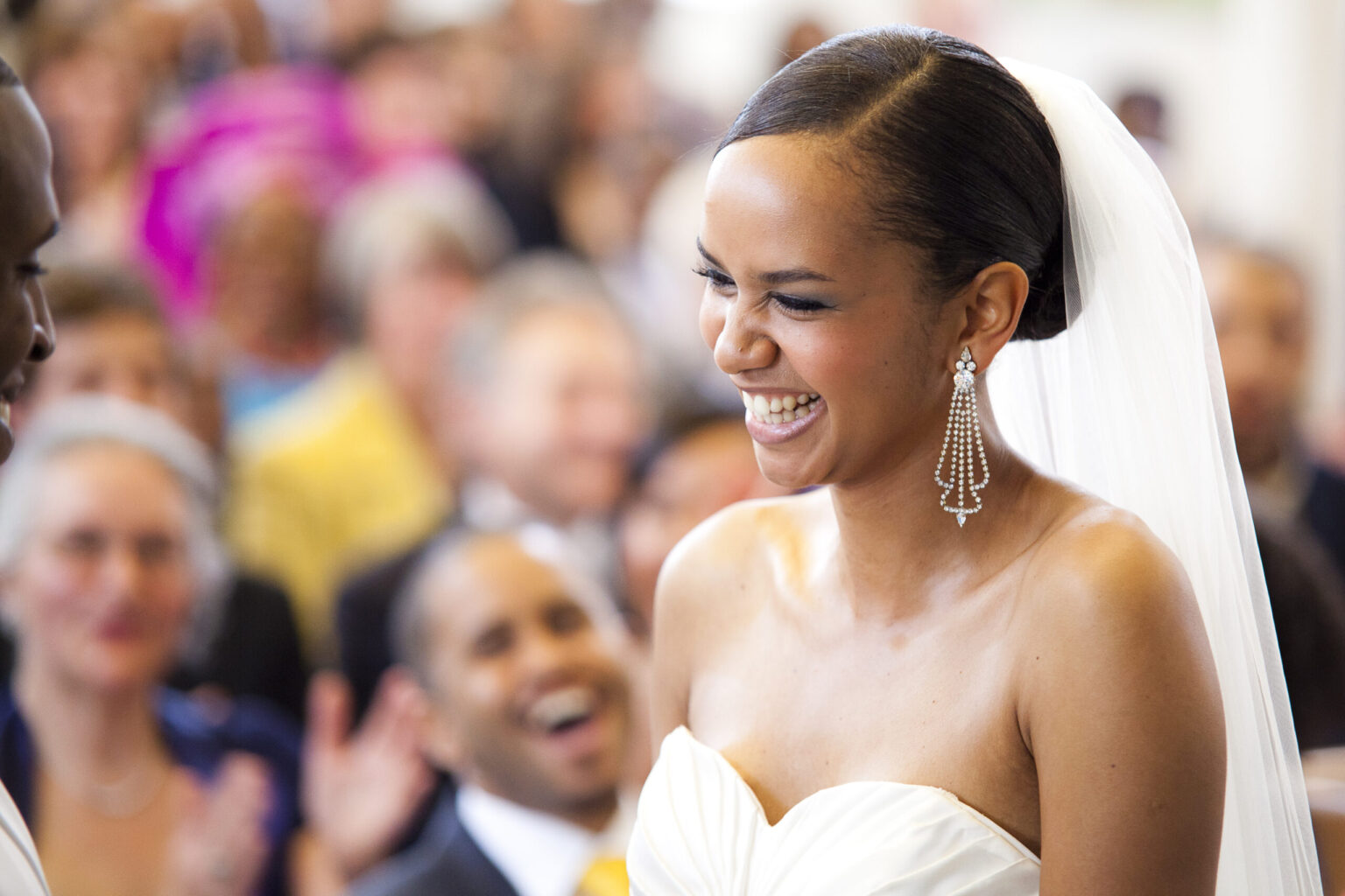 Colour photograph of an african bride smiling with joy at the altar
