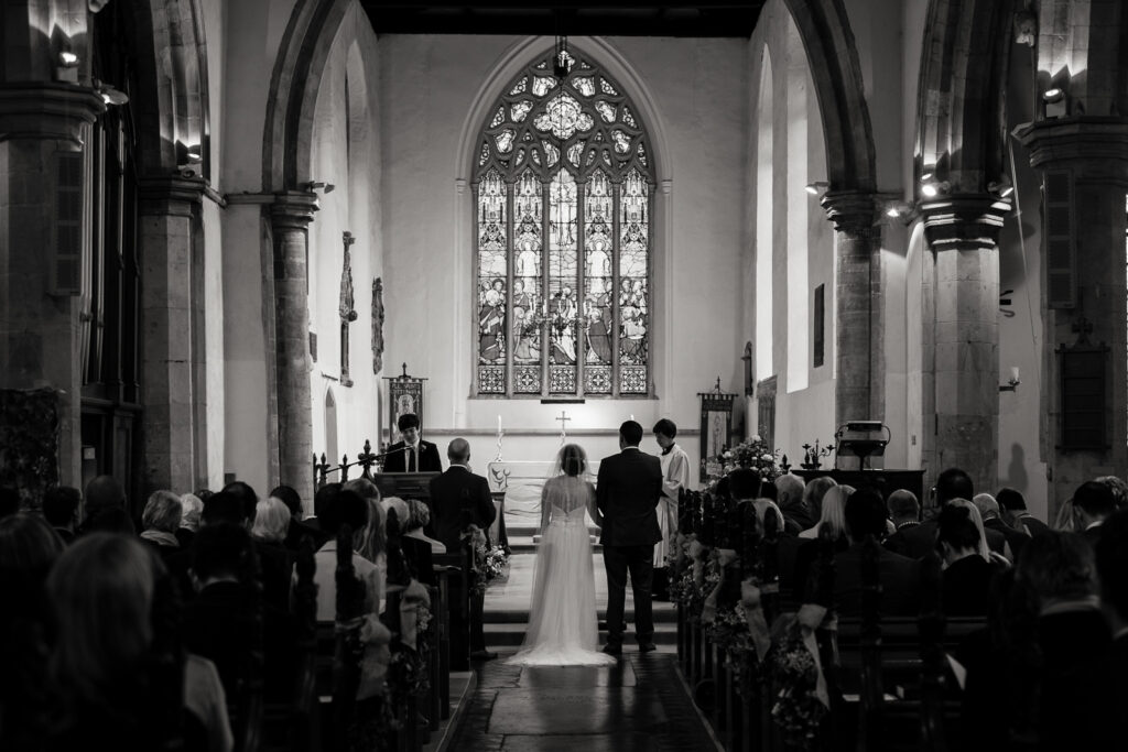 Bride and Groom in Church during the ceremony by Documentary Ottawa Wedding Photographer Sara