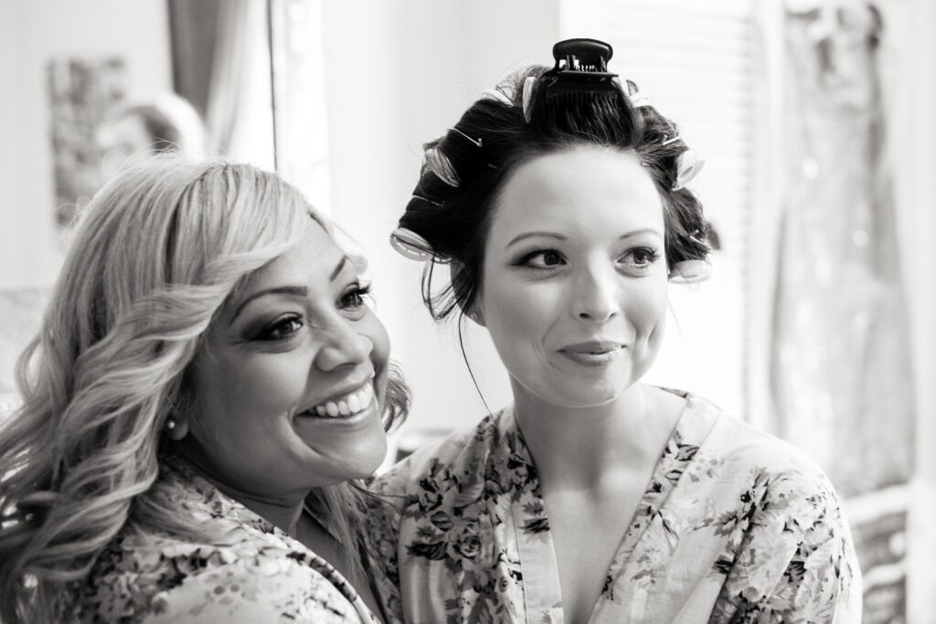 Bridesmaid and Bride getting ready before the ceremony by Ottawa Wedding Photographer Sara