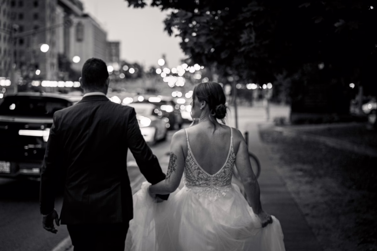 Bride and groom walk down Elgin street in downtown Ottawa by Ottawa Wedding Photographer Sara