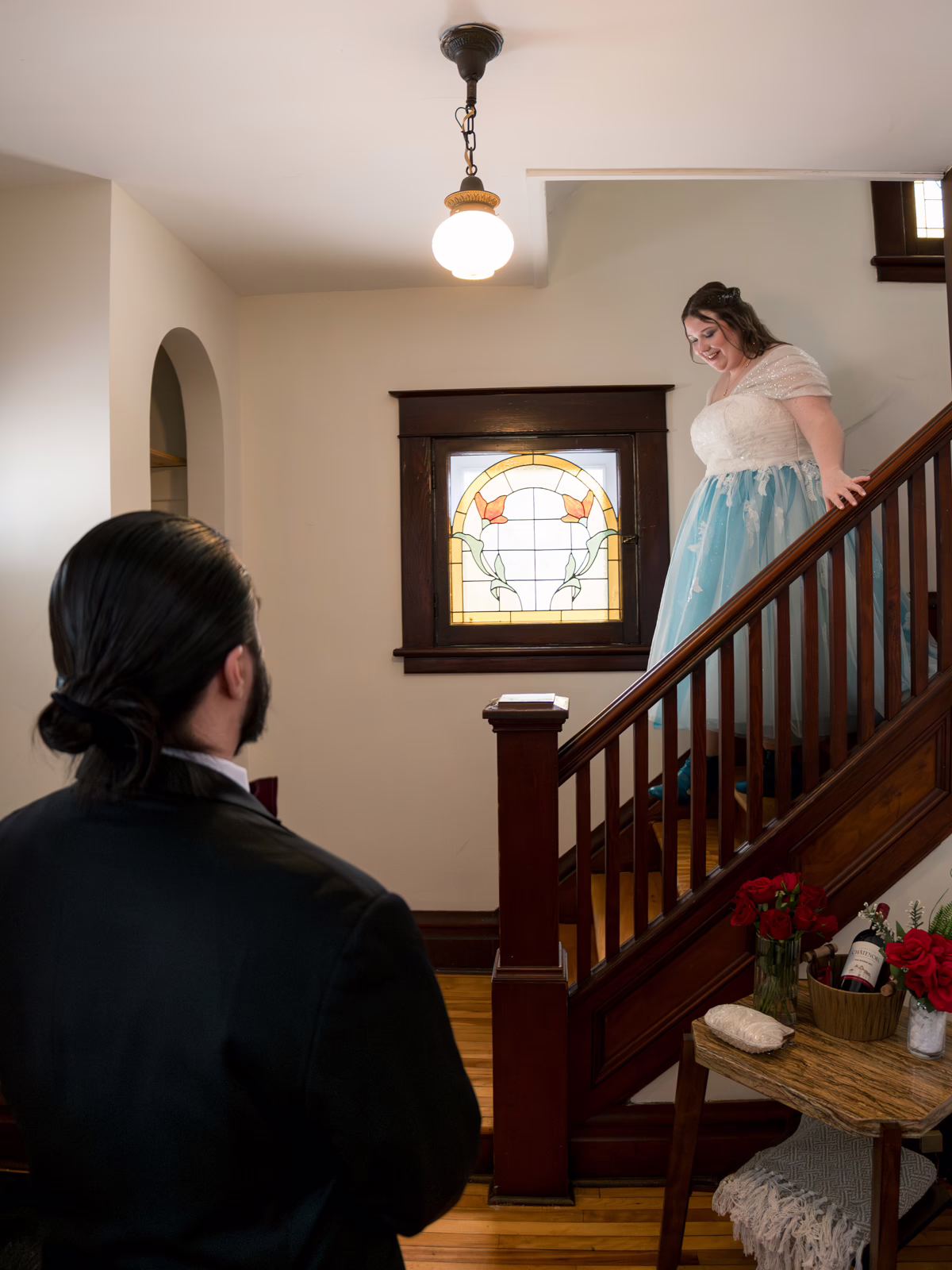The bride walking down the stairs for the first look